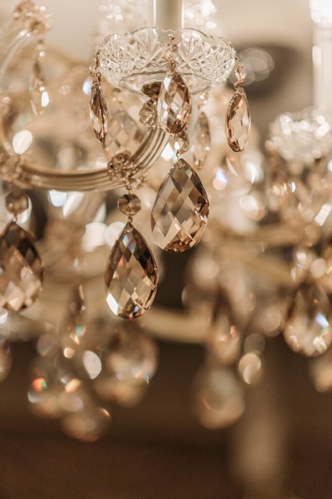 A stunning close-up of a sparkling crystal chandelier with intricate glass details, shining with elegance.