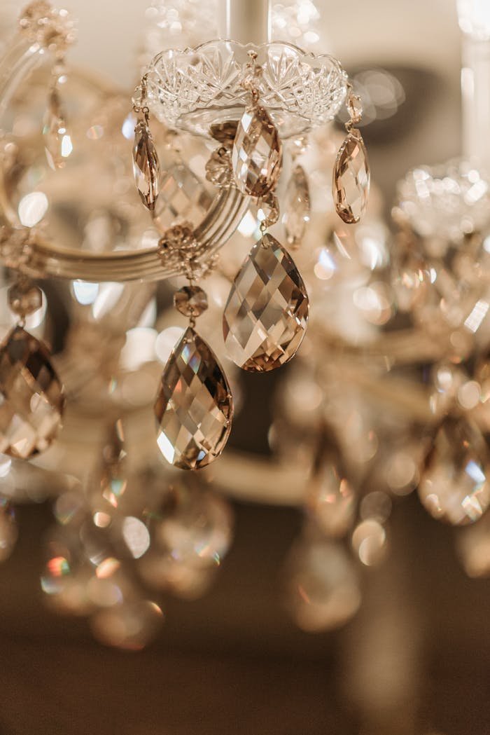 A stunning close-up of a sparkling crystal chandelier with intricate glass details, shining with elegance.